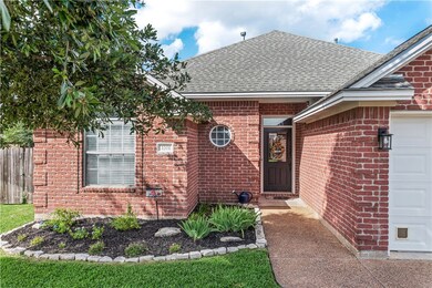 View of exterior entry featuring a shingled roof,