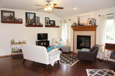 An eye catching fireplace and dark flooring shows 
