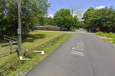 View of asphalt street with traffic signs