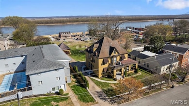 Aerial view of residential area featuring a nearby body of water
