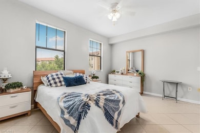 Bedroom with light tile patterned floors and ceiling fan