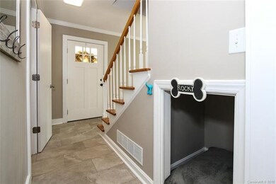 Entry hall has new tile, and plenty of storage wit