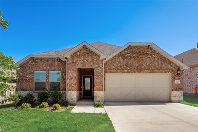 View of front of house featuring a garage and a front yard