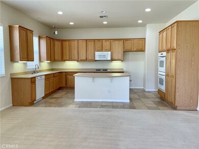 Large, open kitchen with solid surface countertops, double ovens, great for entertaining.