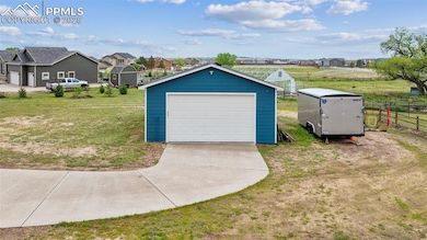 Detached garage featuring a residential view