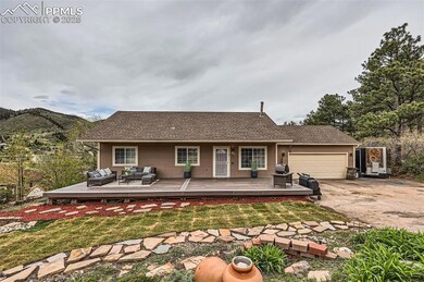 Rear view of house with an attached garage, concrete driveway, an outdoor hangout area, and a yard