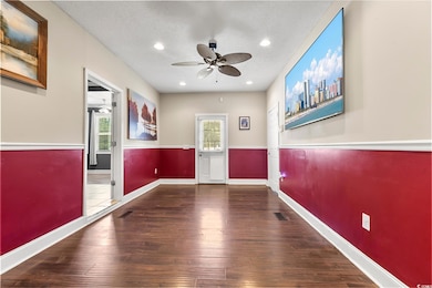 Spare room with ceiling fan, dark wood-style floors, a textured ceiling, and recessed lighting