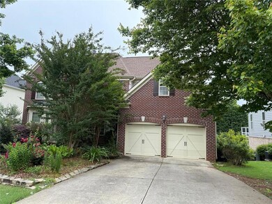 Obstructed view of property with driveway, a garag
