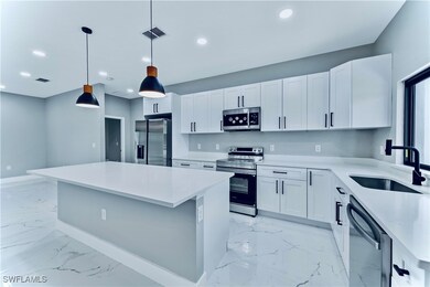 Kitchen with marble finish floor, visible vents, a