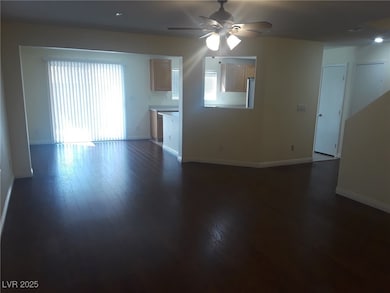 Unfurnished living room featuring a ceiling fan, d