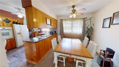Kitchen featuring backsplash, brown cabinets, whit