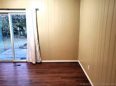 Dining Area with vinyl sliding door to backyard.