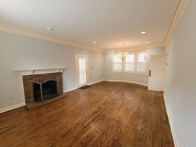 The oversized living room features oak hardwoods, 