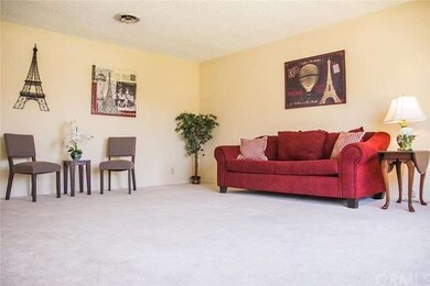 A very large living room just off the entryway with a huge window looking out to the expansive front yard.