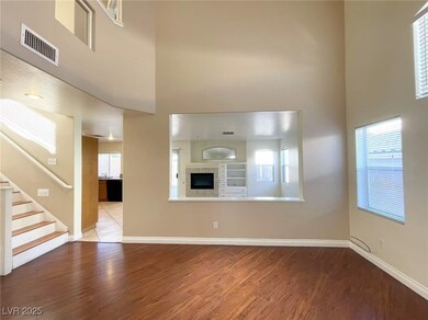 Unfurnished living room with a high ceiling, baseb