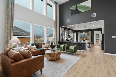 Living room with a towering ceiling and light woo