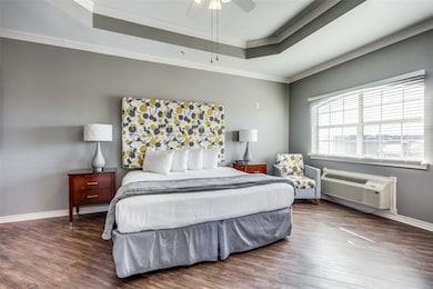Bedroom featuring ceiling fan, dark hardwood / woo