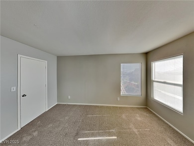 Spare room with a textured ceiling and carpet flooring