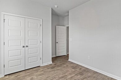 Unfurnished bedroom with light hardwood / wood-sty