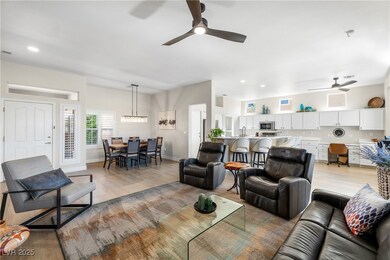 Living room with a ceiling fan, recessed lighting,