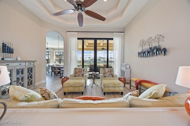 Living room featuring ceiling fan, tile patterned