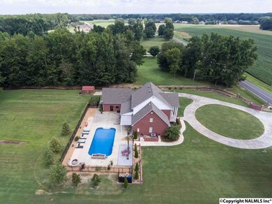 This gorgeous view of this Traditional home features a swimming pool with fire pit and arbor for lots of entertaining.