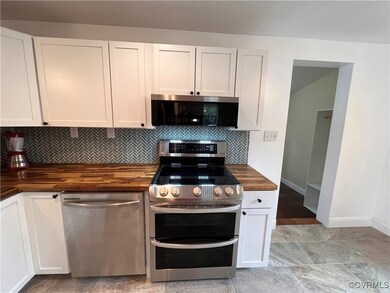 Kitchen with stainless dishwasher, microwave, and
