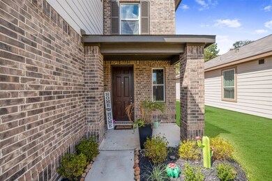 A nice covered front porch with landscaping greets your guests as they arrive.