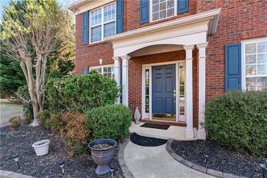 Property entrance featuring brick siding