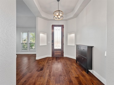 Foyer entrance with chandelier and built ins