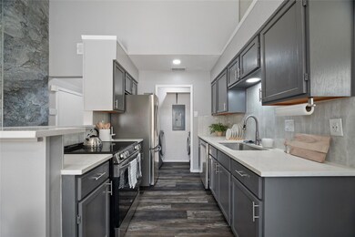 Kitchen with gray cabinets, appliances with stainl