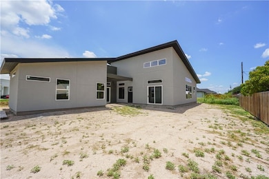 Rear view of property featuring stucco siding