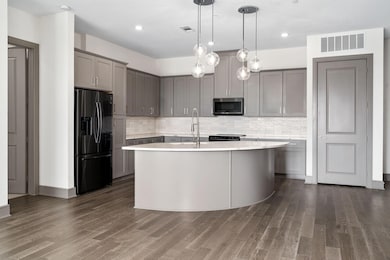 Kitchen featuring a center island with sink, sink,