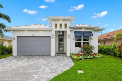 View of front of house with a garage and a front y