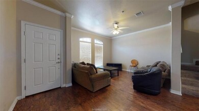 Living room featuring visible vents, ornamental mo