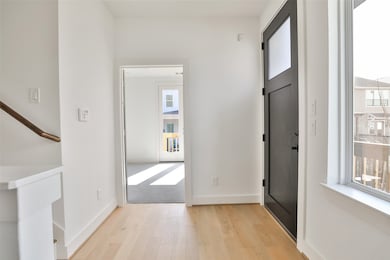 To your right, a bedroom awaits, enhanced by crisp