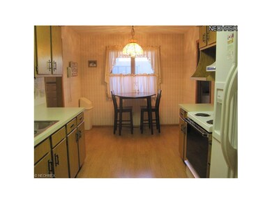 Kitchen has place for breakfast table and newer laminate flooring.