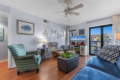 Living room with visible vents, ornamental molding