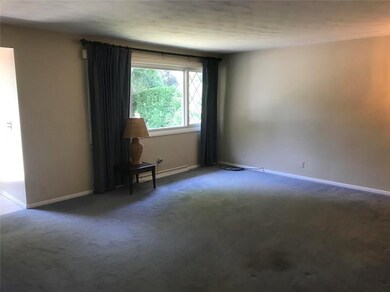 Living room is nice size with hardwoods under carp