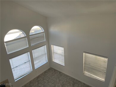 Empty room with baseboards and a high ceiling