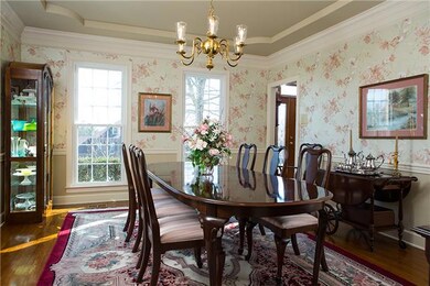 The elegant formal dining room offers more than enough space for large families to gather around the dinner table.