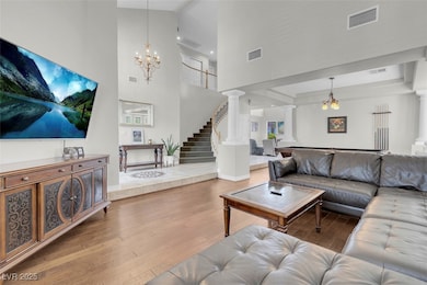 Living room featuring ornate columns, wood finishe