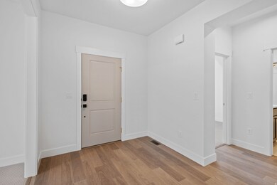 Foyer featuring light wood-type flooring and baseboards