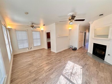 Unfurnished living room with a ceiling fan, light