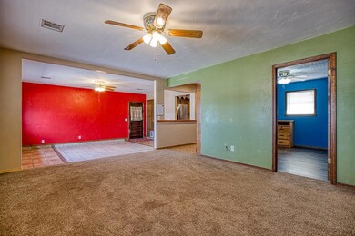 Spare room featuring ceiling fan, a textured wall,