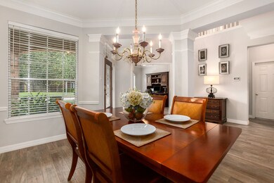 The entry is flanked by a charming formal dining room and across the hallway the study!  Crown molding and columns add just that extra flare for your dining pleasure!