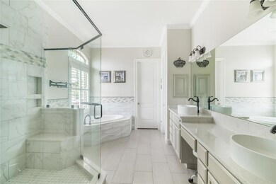 Bathroom with double vanity, a bath, ornamental m