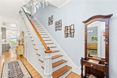 Spacious Foyer to Greet Family and Friends Complete with Hardwood Flooring and Gorgeous Staircase Detail!