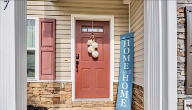 Entrance to property featuring stone siding