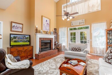 Living room with ceiling fan, high vaulted ceiling